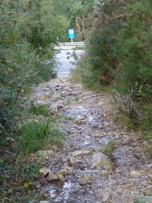 You can see the blue sign at the end . . . it holds a shell AND an arrow